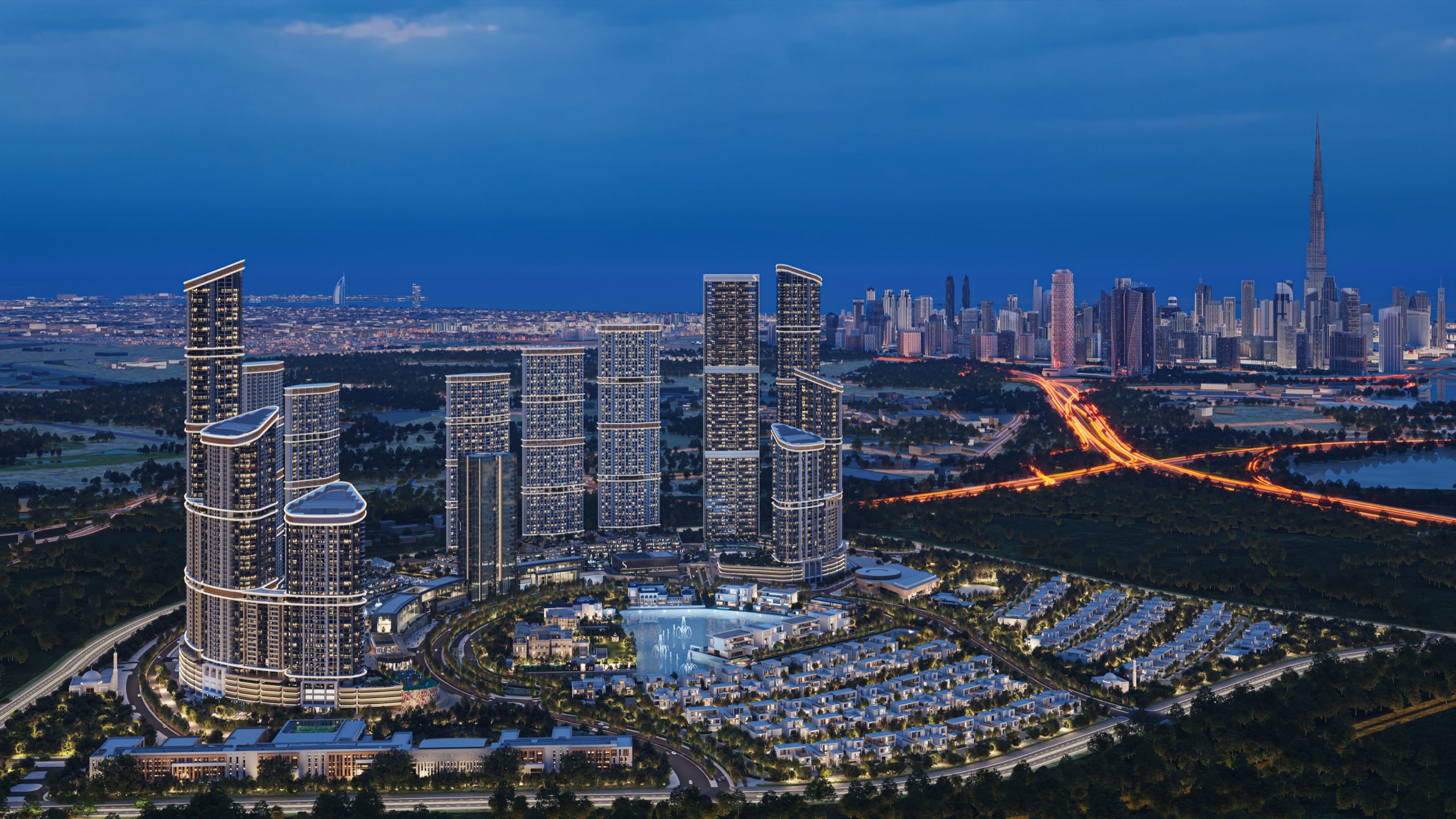 Sobha Hartland II master community at night, with the Dubai skyline beyond